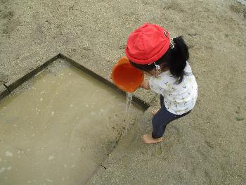 バケツで水を運ぶ子ども