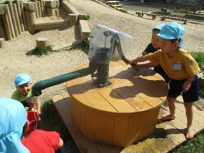ポンプから水を出す子どもたち