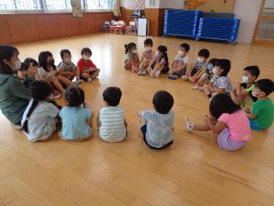 保育者の話を聞く子ども